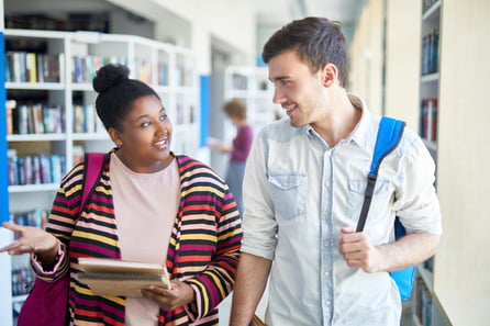 College students walking in the library