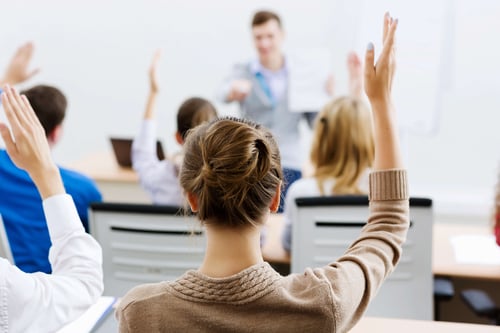 College Student Raising Her hand in Class