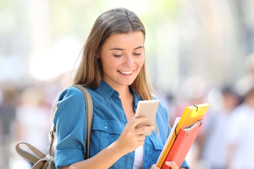 College girl looking at her phone