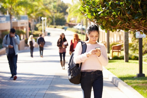 Female student texting on campus